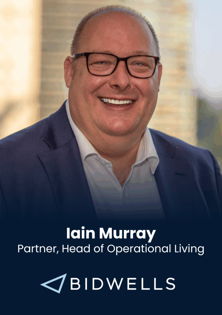 Head-and-shoulders portrait of Iain Murray in a navy suit and glasses, smiling; banner includes his name and Bidwells branding in the background.
