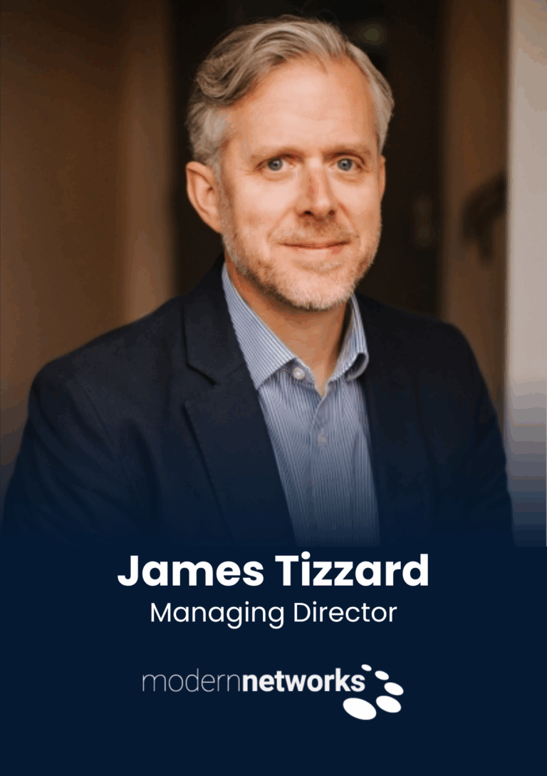 Professional headshot: middle-aged man in a navy blazer, light striped shirt, smiling, with text reading 'James Tizzard' and 'Managing Director' and the 'modern networks' logo below.