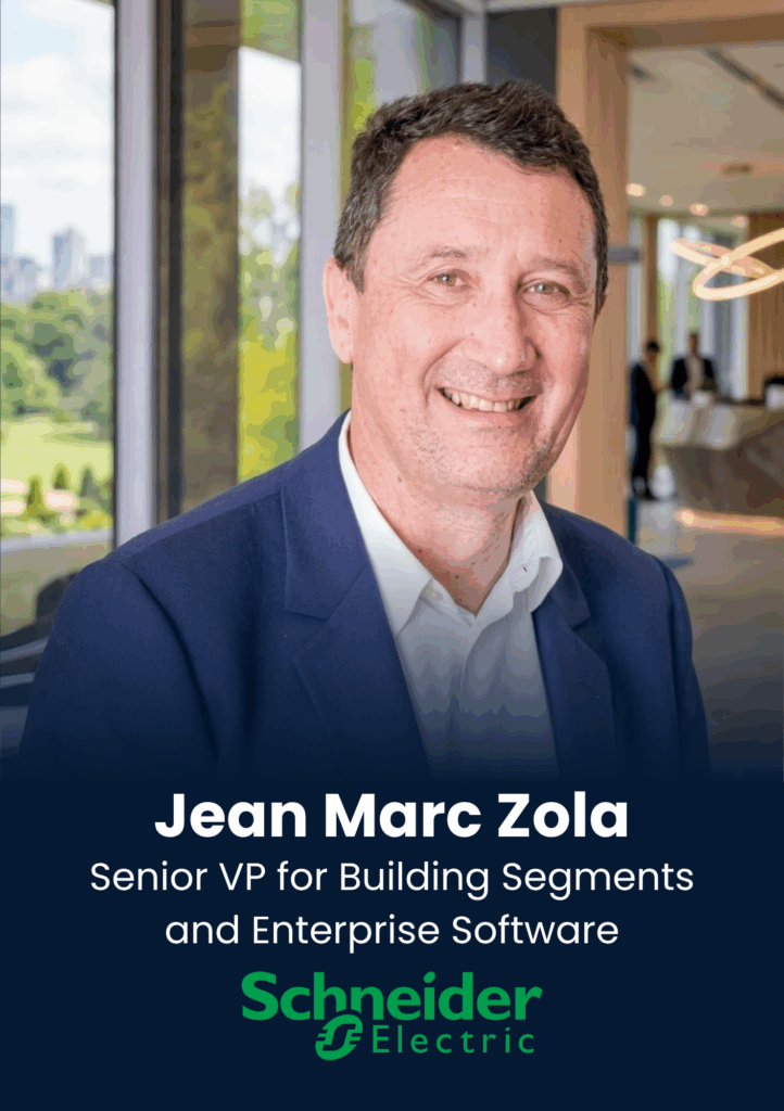 Portrait of a smiling man in a navy suit in a bright office lobby, with the name Jean Marc Zola and Schneider Electric logo overlay.