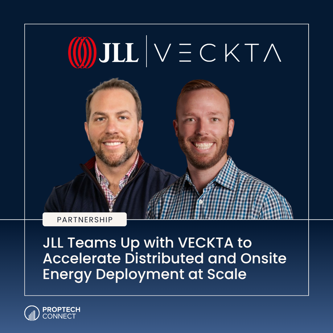Two men smiling in front of a navy banner with JLL | VECKTA logos and a 'PARTNERSHIP' badge; headline mentions accelerating energy deployment at scale.