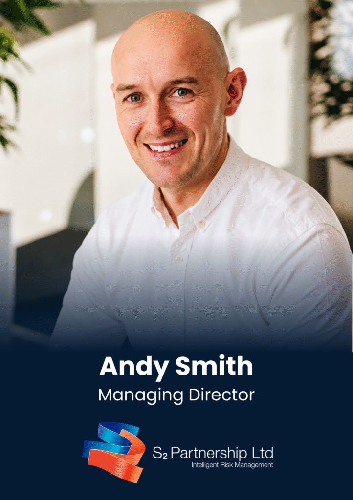 Portrait of Andy Smith, smiling, in a white shirt, with 'Managing Director' and company branding visible at the bottom (S2 Partnership Ltd).