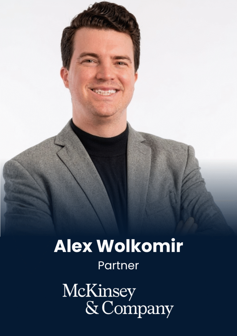Professional headshot of Alex Wolkomir, a Partner at McKinsey & Company, smiling in a gray blazer.
