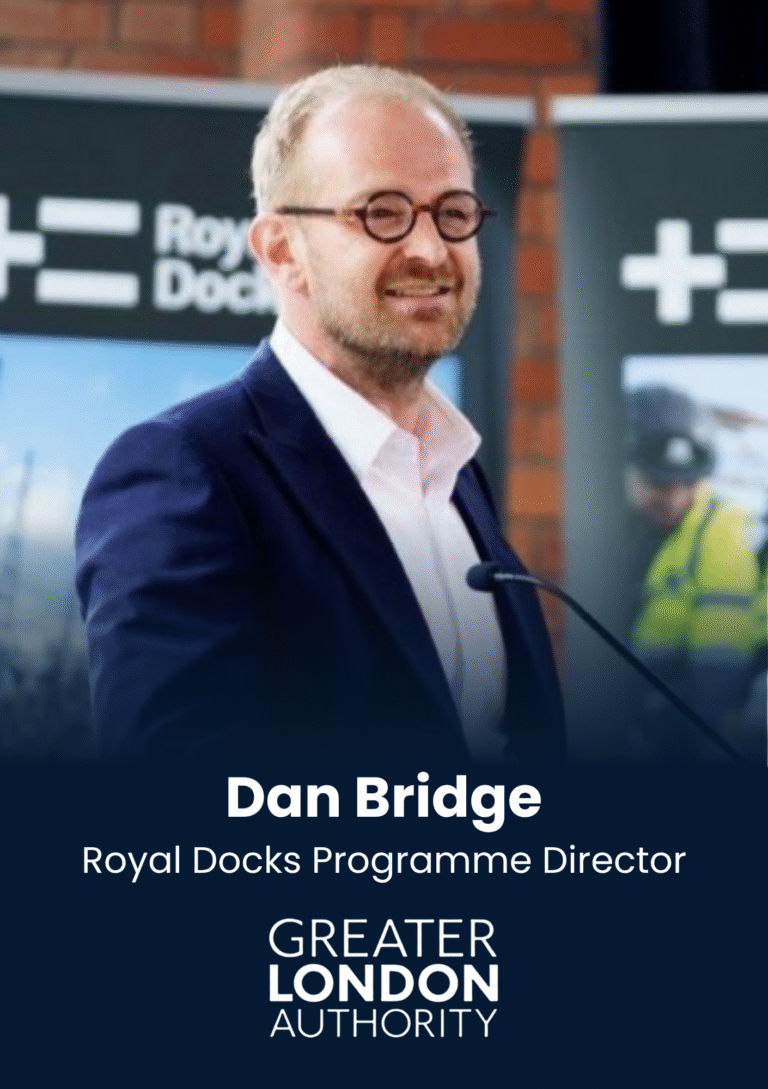 Portrait of Dan Bridge, Royal Docks Programme Director, speaking at an event with branding in the background.