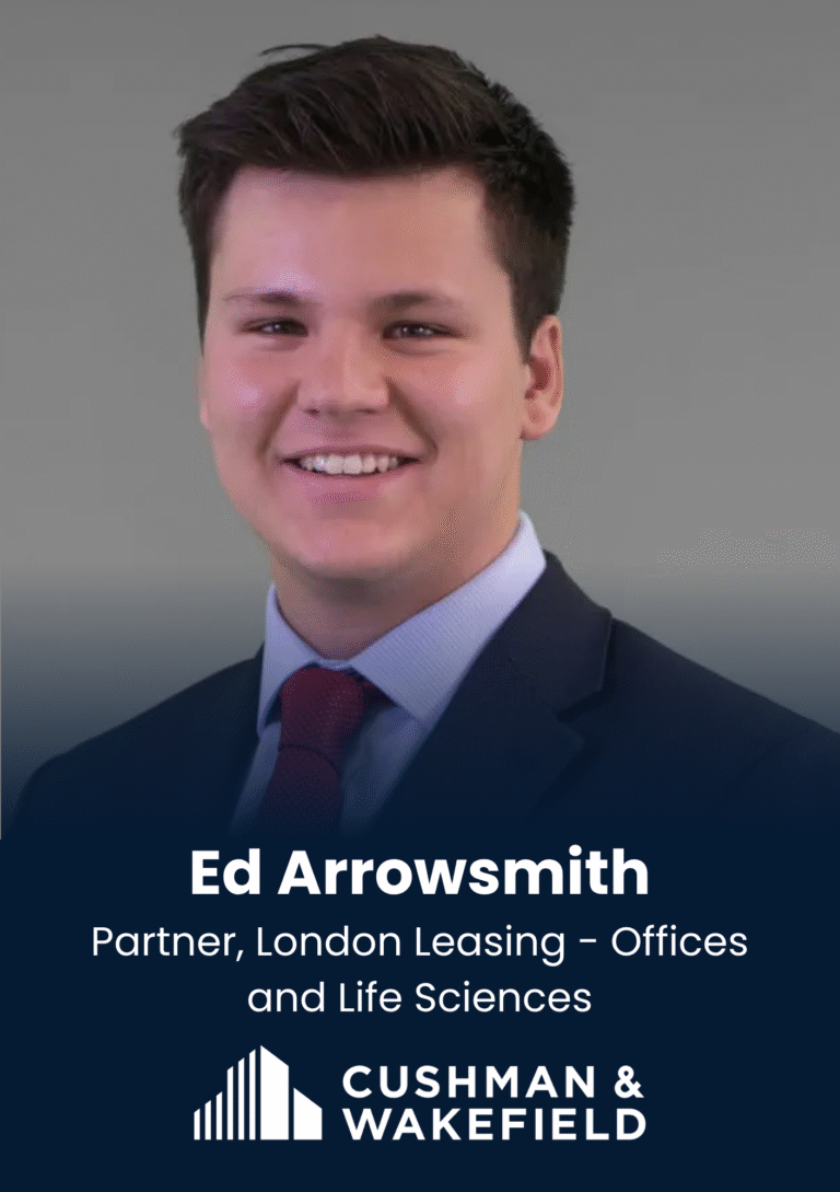 Professional headshot of Ed Arrowsmith in a suit and red tie, smiling at the camera.