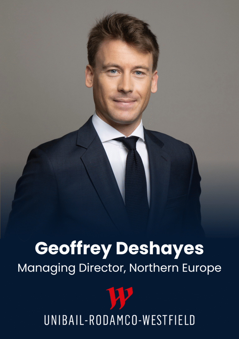 Portrait of Geoffrey Deshayes in a navy suit and tie, smiling, against a neutral gray background, with title 'Managing Director, Northern Europe'.