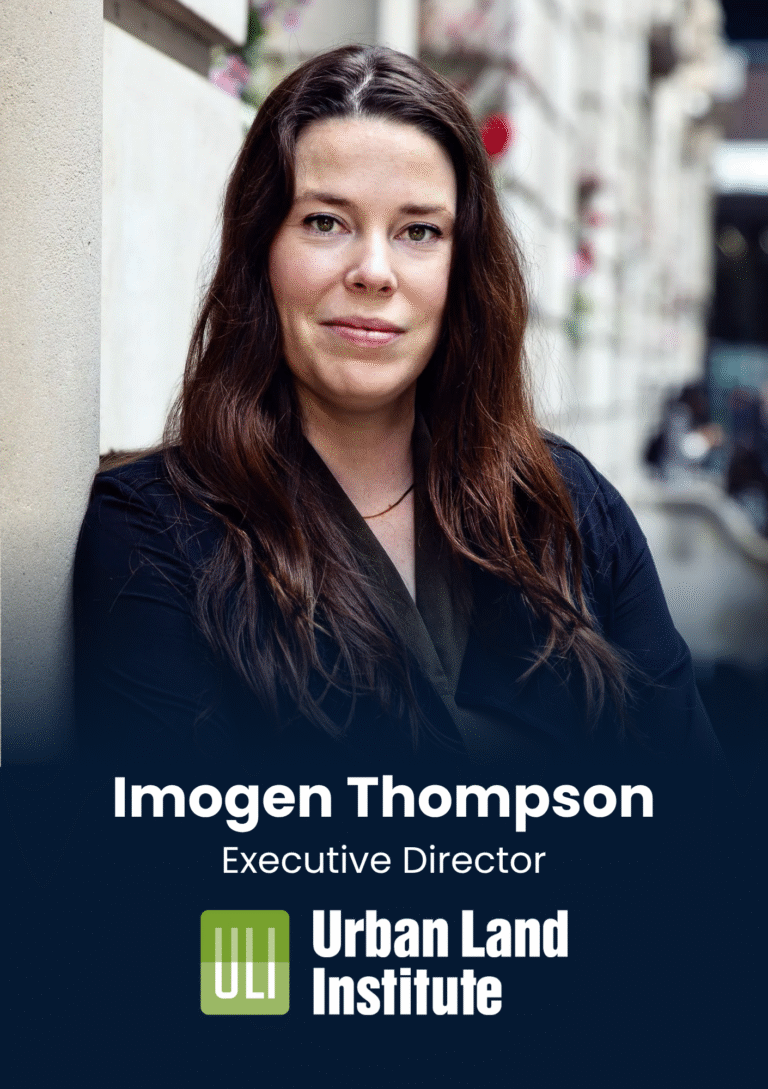 Portrait of Imogen Thompson, Executive Director for Urban Land Institute, outdoors beside a stone wall.