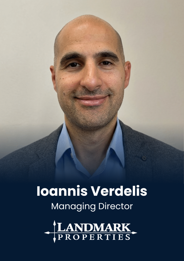 Portrait of Ioannis Verdelis, managing director, wearing a blue shirt and gray blazer in a head-and-shoulders shot to represent a corporate profile.