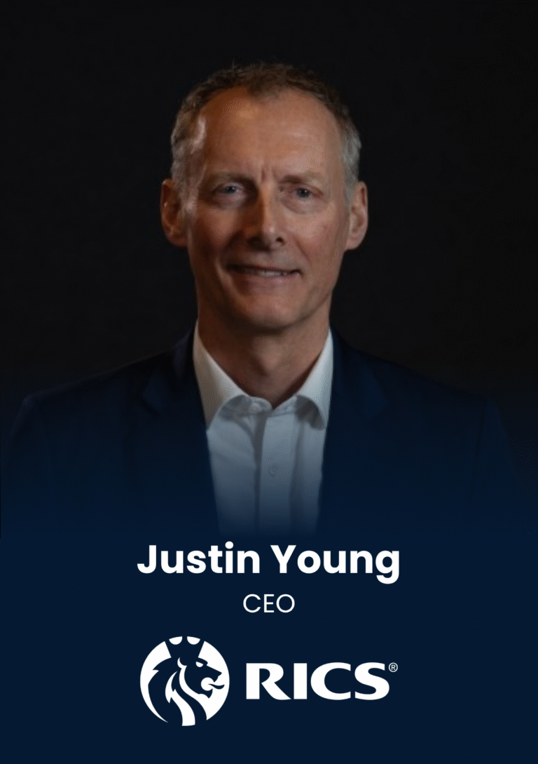 Portrait of Justin Young, CEO, in a dark studio with RICS logo below him