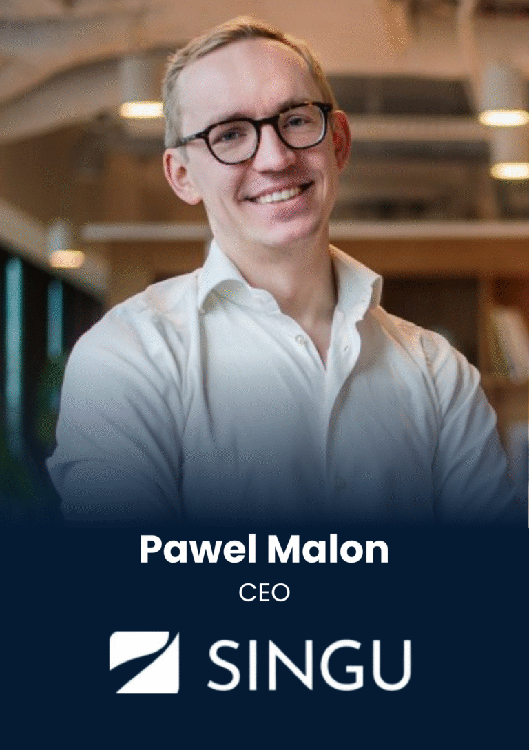 Portrait of Pawel Malon, CEO, smiling in a white shirt with an office backdrop, used for a company profile.