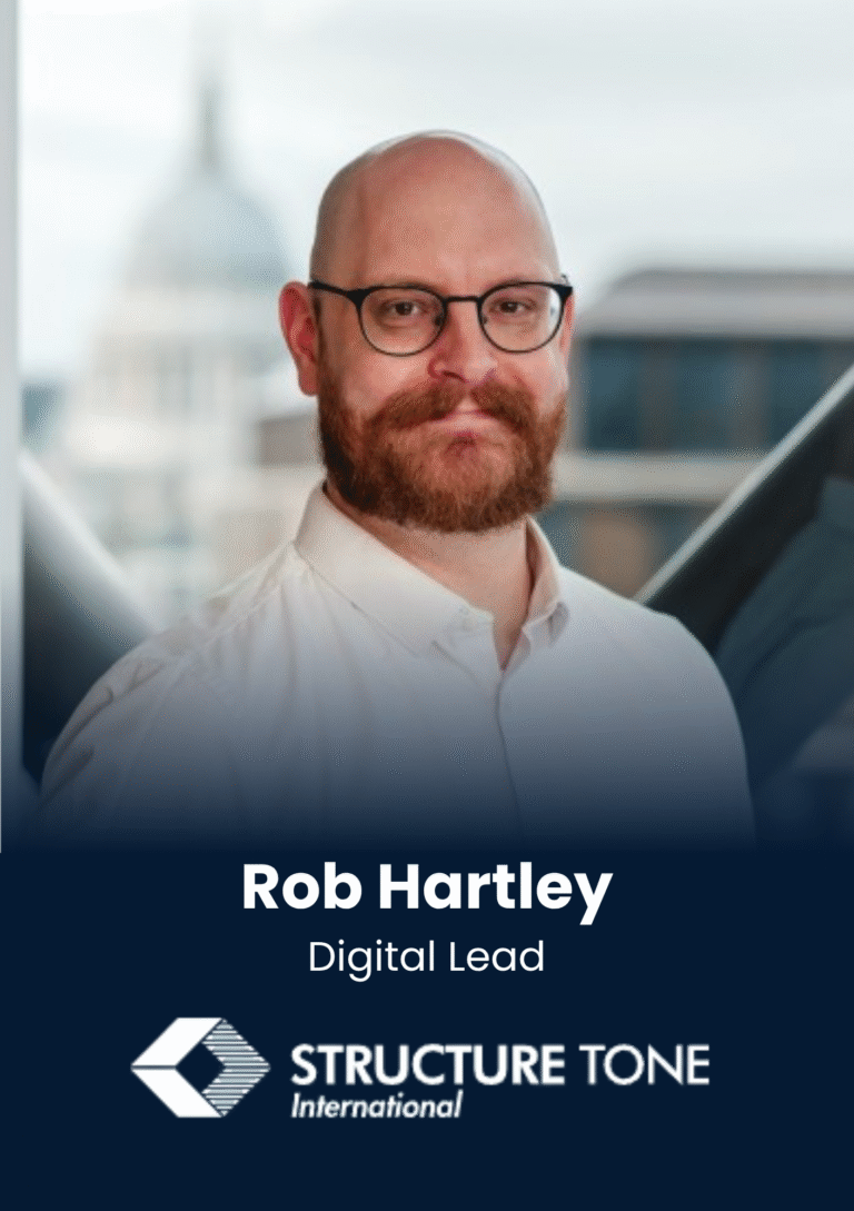 Portrait of Rob Hartley, Digital Lead, in a bright office setting with a blurred background and branding at the bottomic centerpiece.