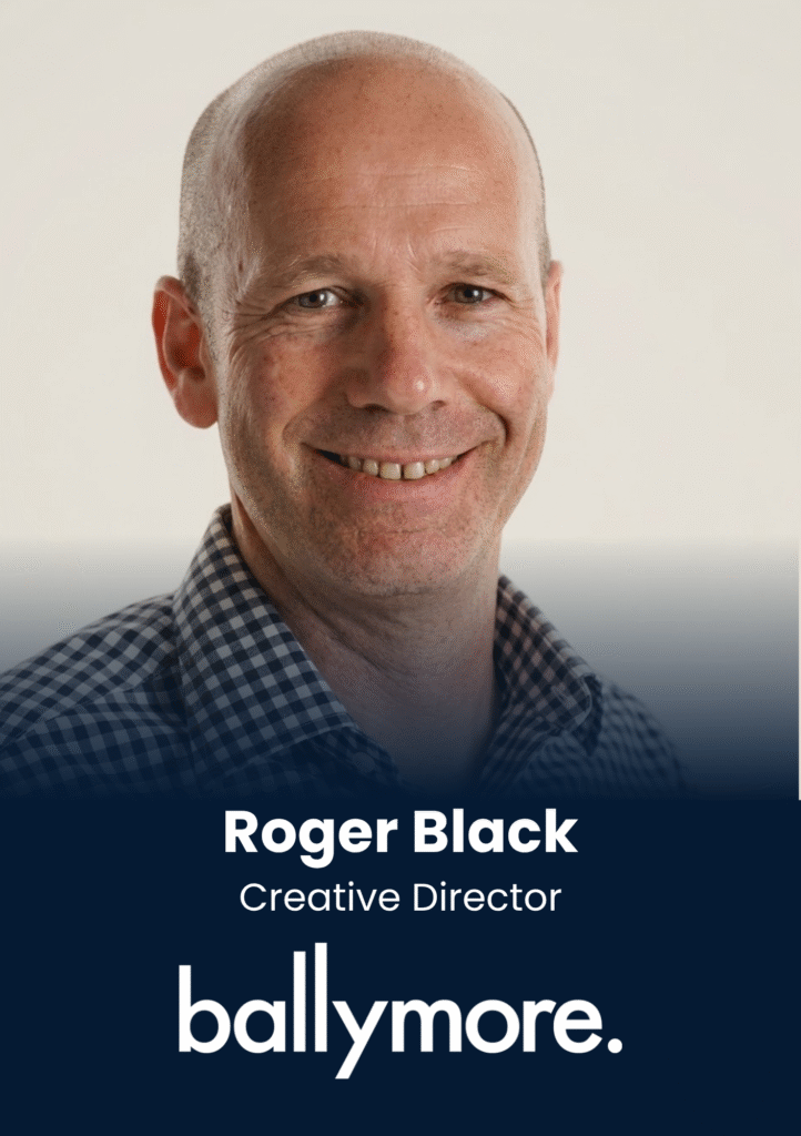 Portrait of Roger Black smiling, wearing a checkered shirt, used for a team profile slide.