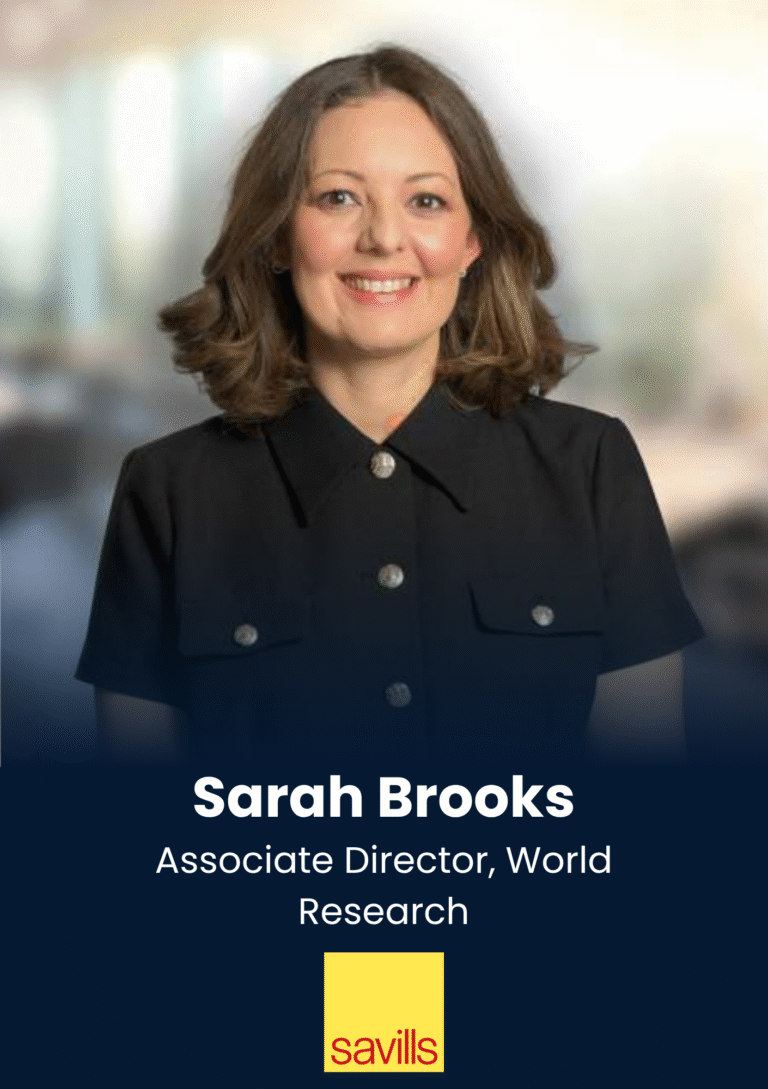 Head-and-shoulders portrait of Sarah Brooks, Associate Director, World Research, in a dark blouse with a blurred office background.