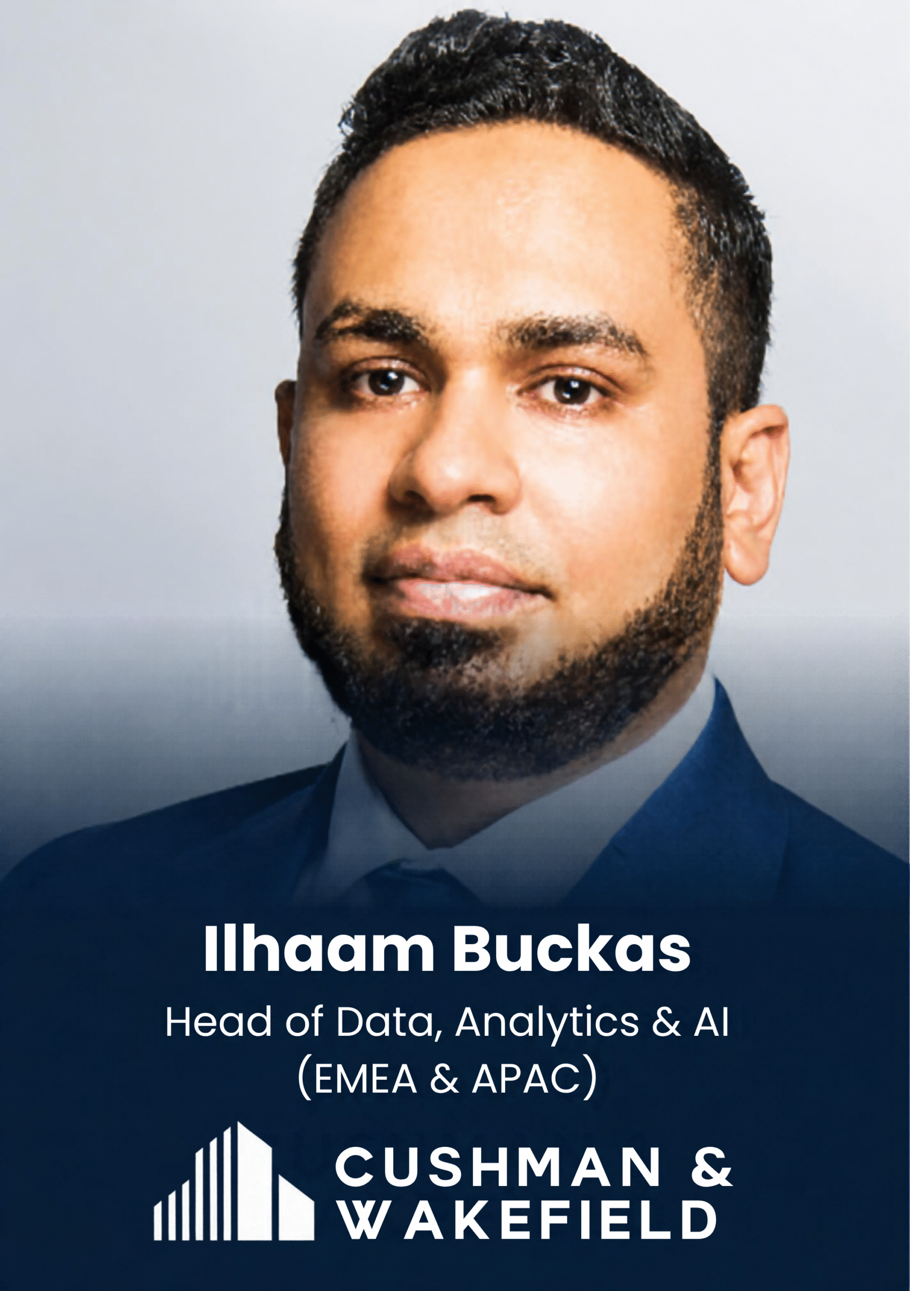 Portrait of a man in a blue suit against a gray background, used as a speaker/profile photo (name shown on slide: Ilham Buckcas).