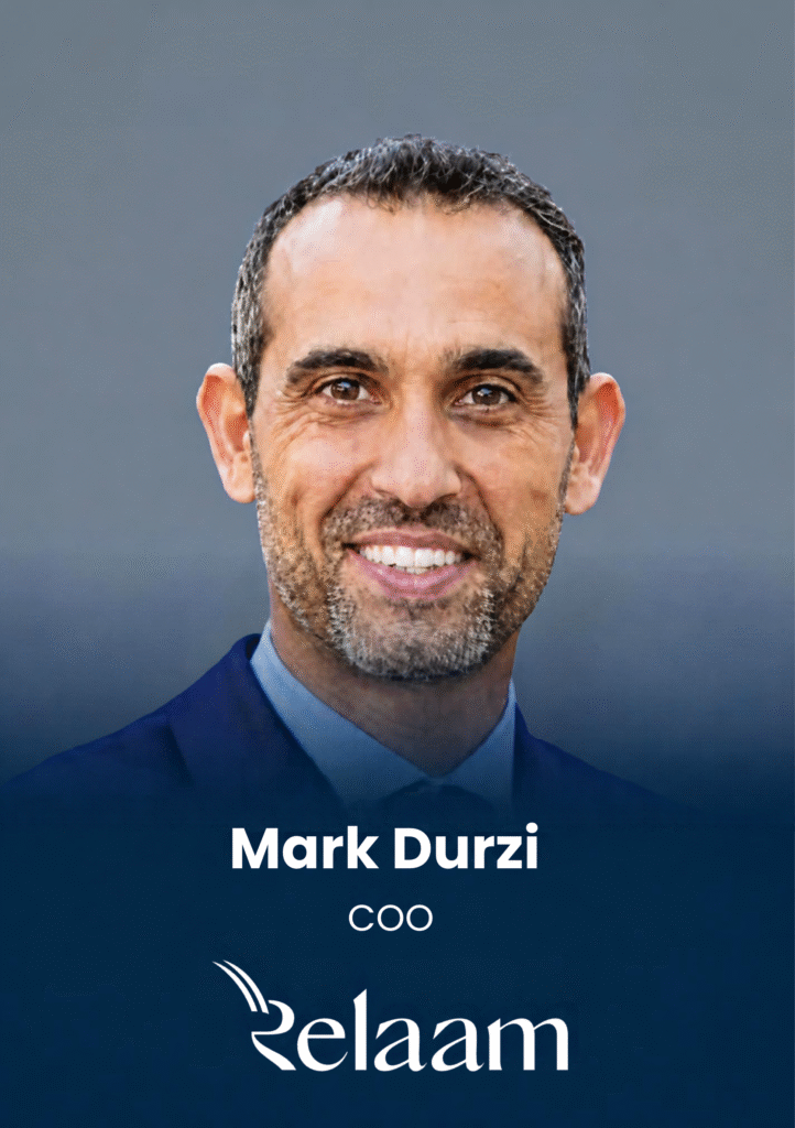 Portrait of Mark Durzi, CEO, in a blue suit with a dark gradient background and company logo at the bottom (Relam).